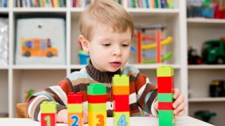 child playing with number blocks