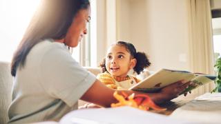 child and parent reading at home 