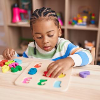 child playing with number blocks