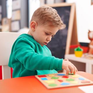 child with shape blocks