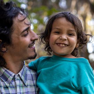 boy and dad smiling